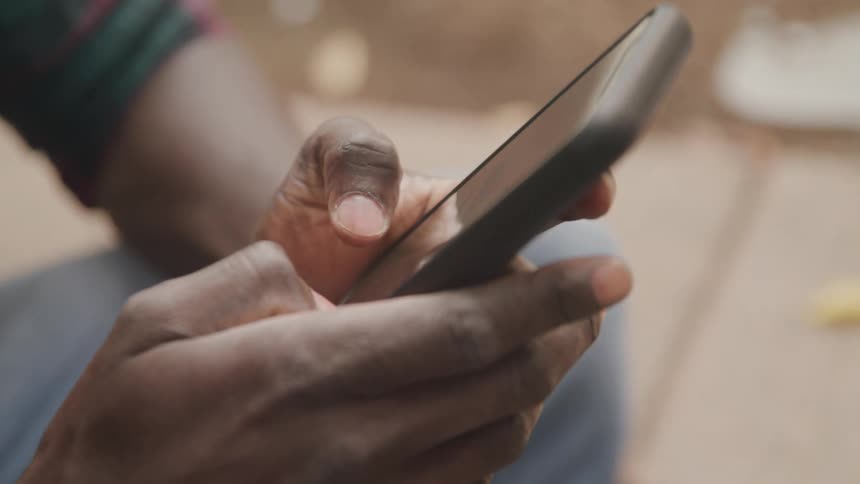 Closeup of a persons hands typing on a smartphone