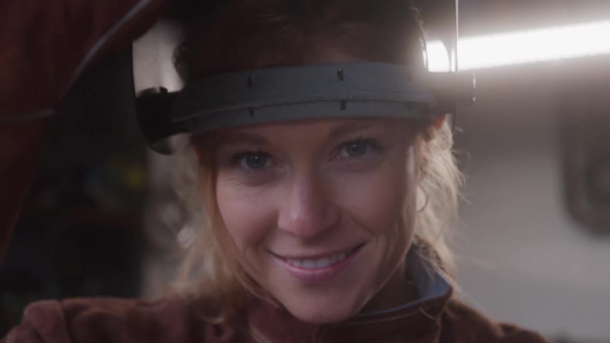 Woman opening metalworkers mask