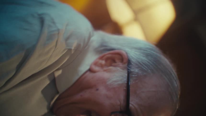 Elderly man sitting vibrating happily