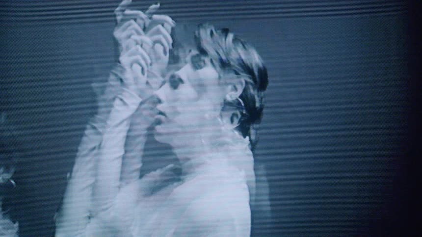 Woman with short hair and big earring modeling on a closed environment