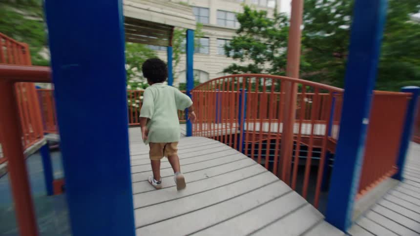 The boy is running in the playground