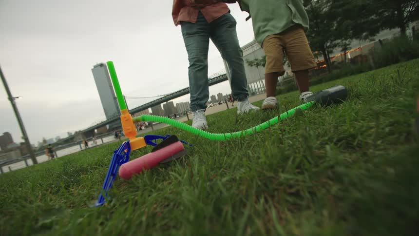 Boy stepping on a toy in an outdoor park
