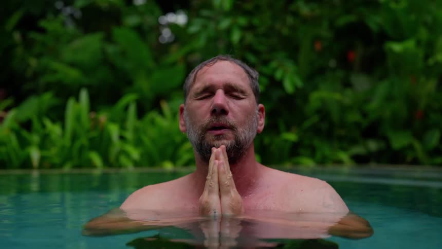 Man relaxing in a swimming pool