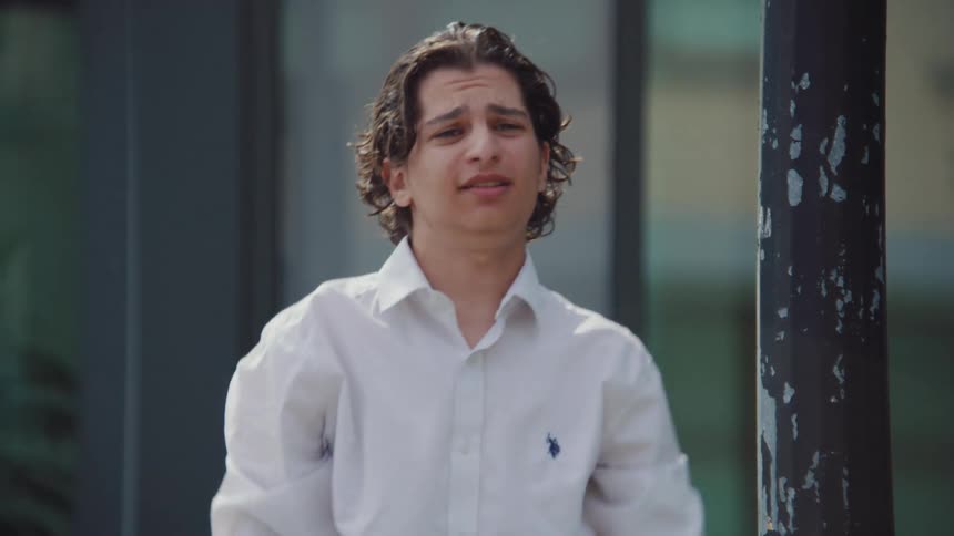 A man is yelling by the building