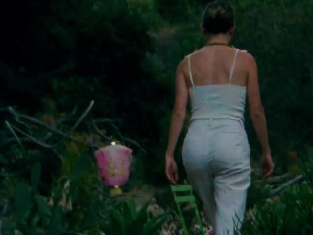 A footage of a lady walking in a garden