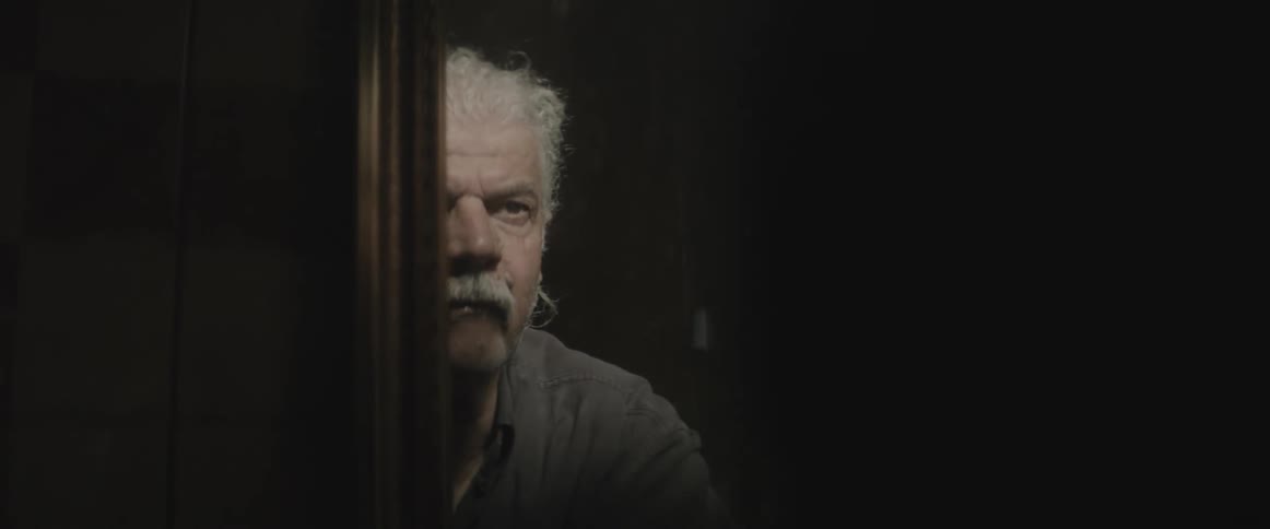 A man looks at his reflection in a mirror