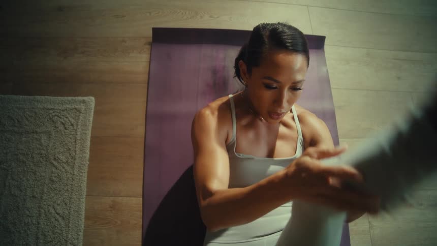 A woman laying on her back alternates between kicking her legs upwards