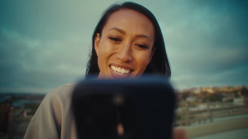Woman outdoors interacting with a smartphone