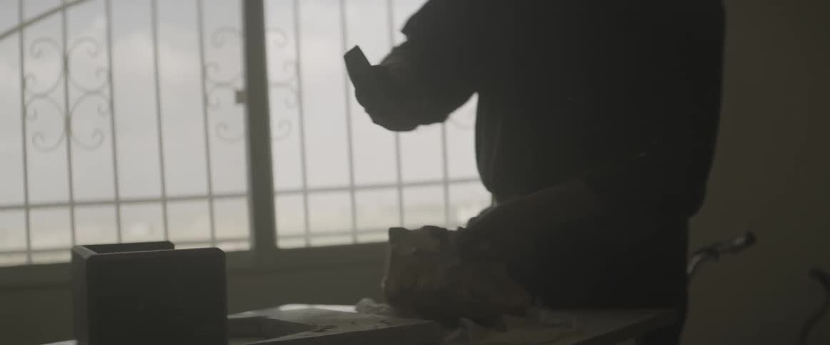 A man works with a chisel and hammer