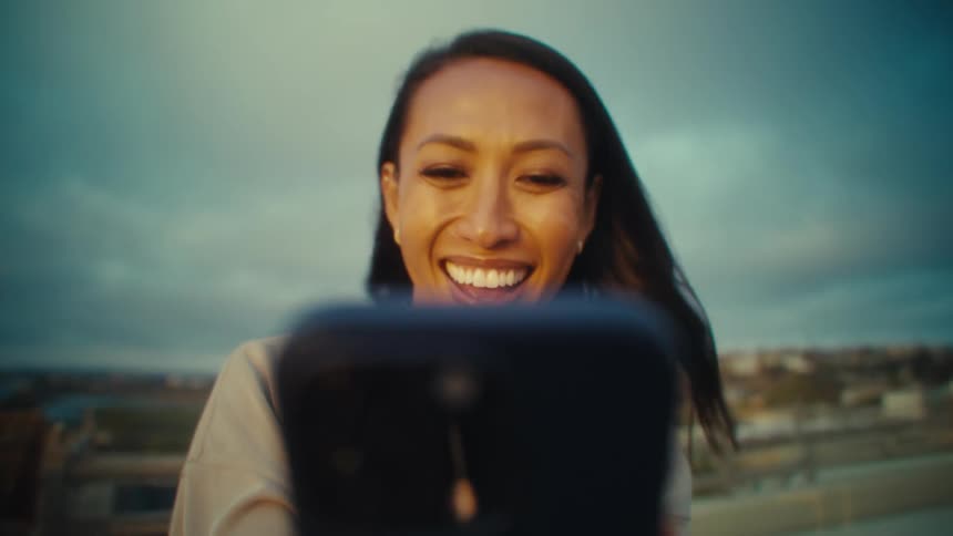 A young woman holding a phone taking a selfie