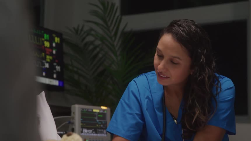 Nurse interacting with a patient who is lying down