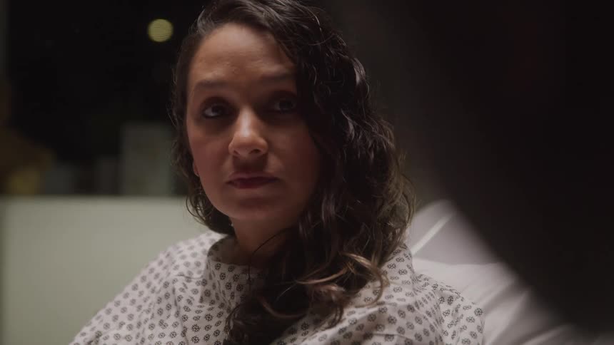 The patient nods her head in the hospital bed