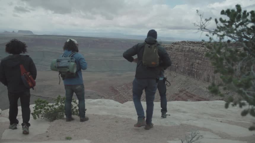 Group of people sightseeing on top of a mountain