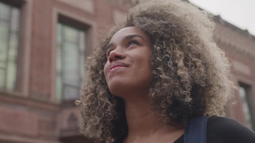 Woman with curly hair outdoors