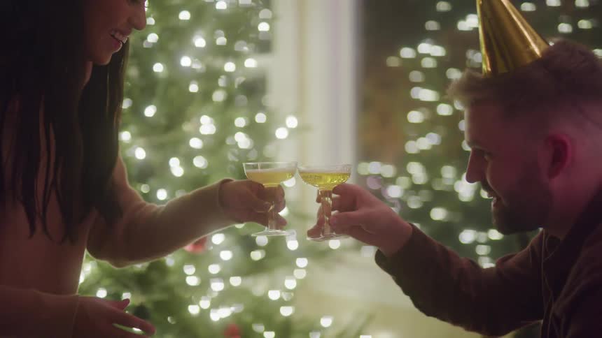 A woman hands a man a drink at the party
