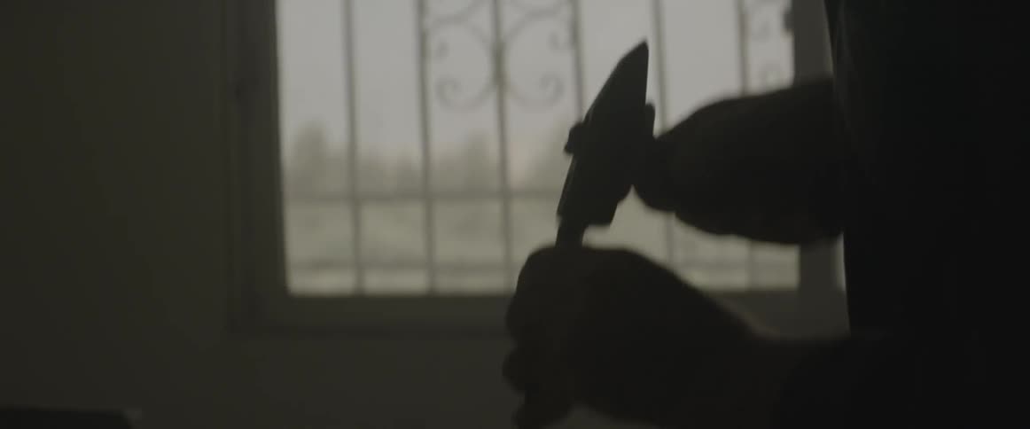 A man is hammering carving some stone