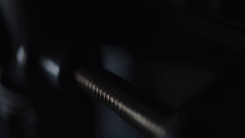 Closeup of a screw attached to a bracket