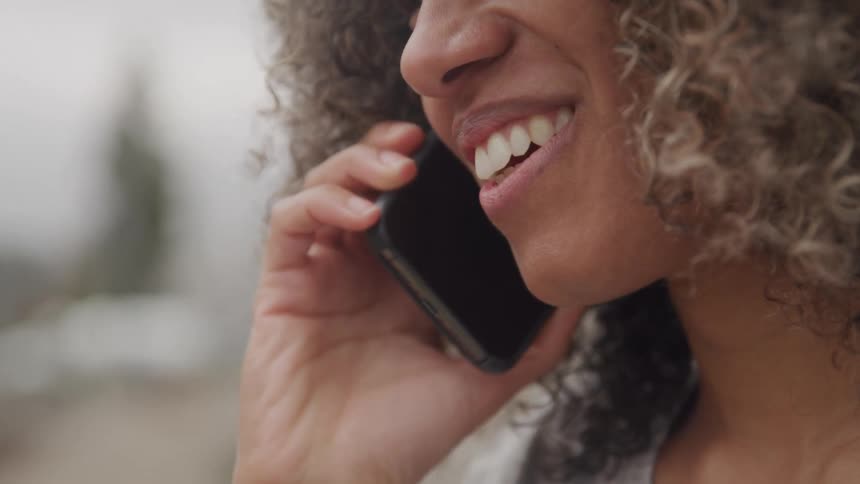 Close up of a smiling female talking on her cell phone