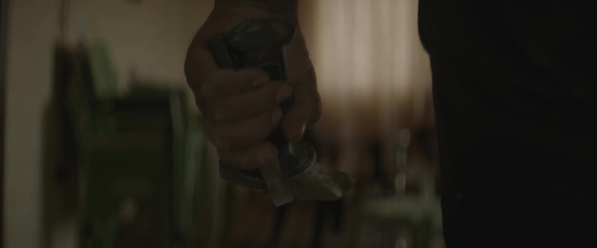 A man holds a chisel and hammer