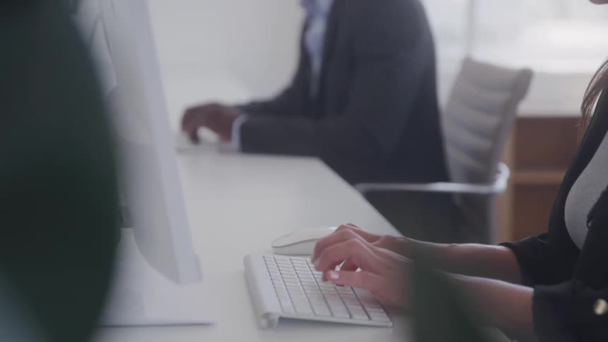 Workers are typing on computers in the office