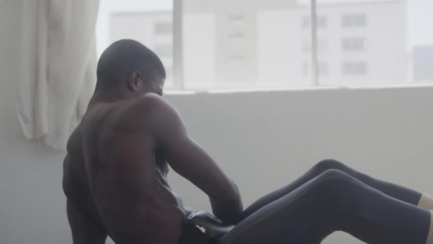 Male intensely doing core workout with a medicine ball