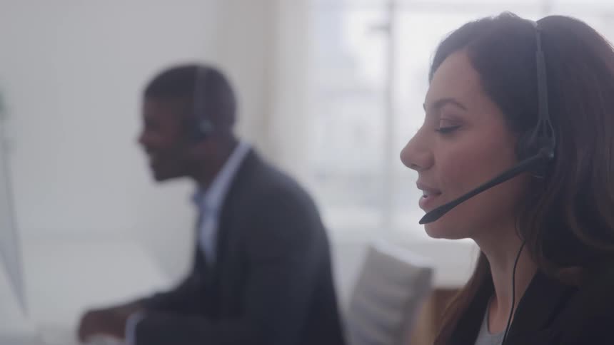 Man and a woman with headphones in an office meeting
