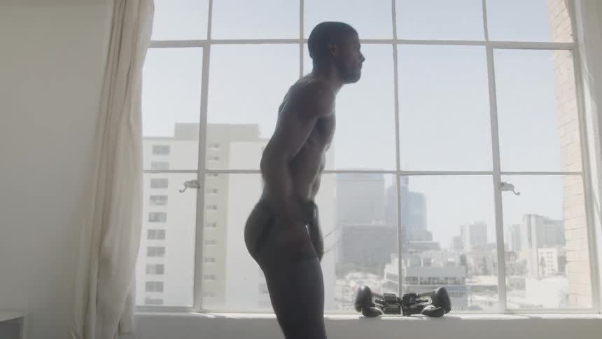 A man is jumping rope fast by the window