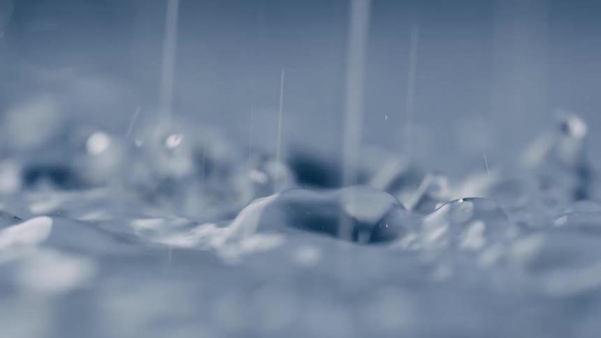 Rain pours down in the puddle