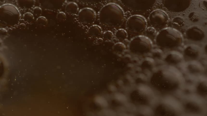Dark swirling liquid bubbles rising to the top