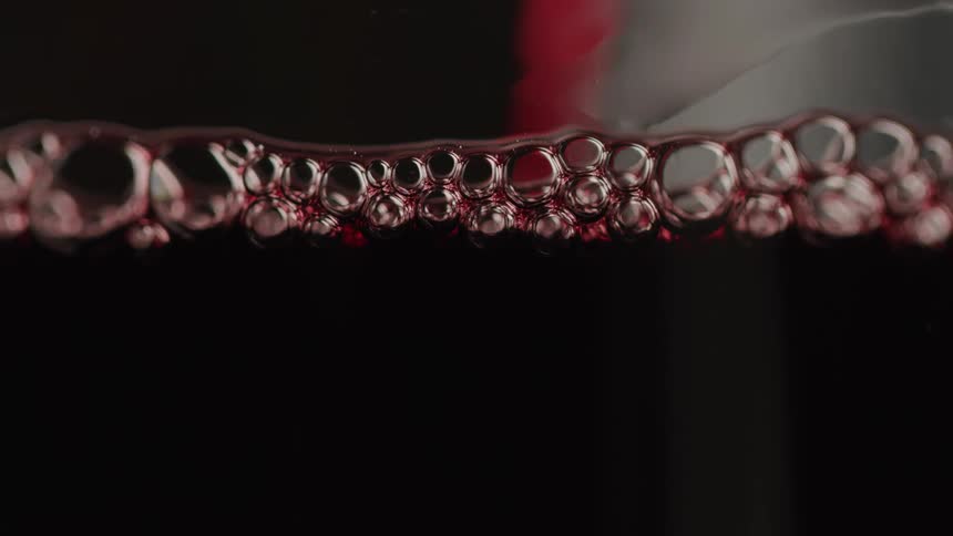Red wine poured into a glass