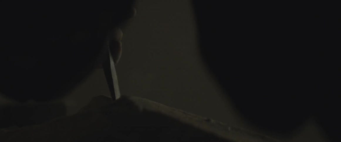 A chisel is being hammered near a window
