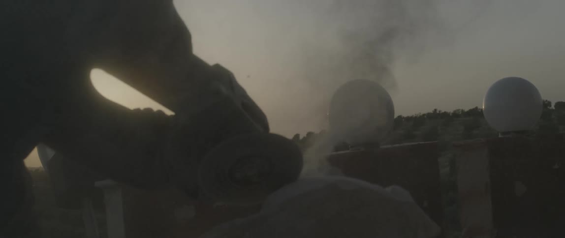 A man works with a grinder outside