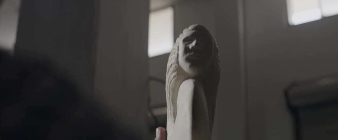 A man rubs a statue