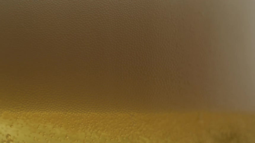 The glass is slowly filled with beer