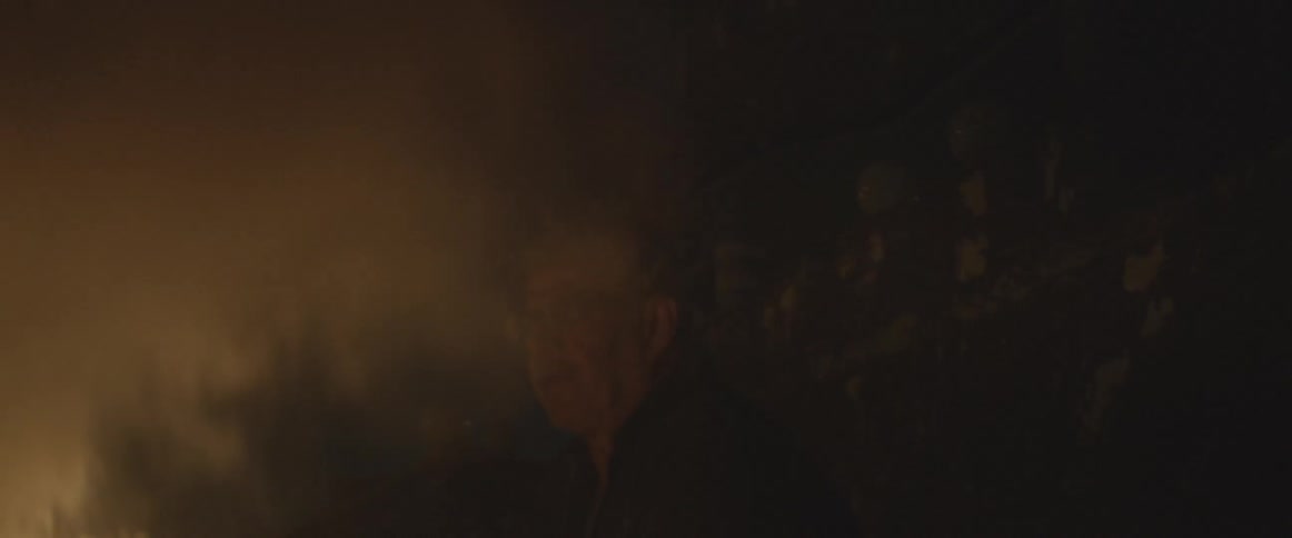 A man walks toward a fire