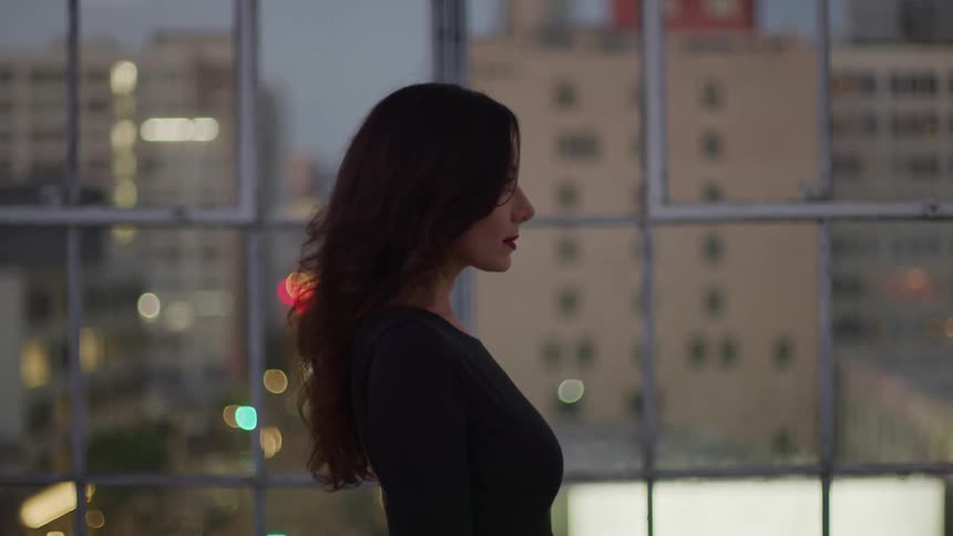 Woman in an indoor space with buildings in the background