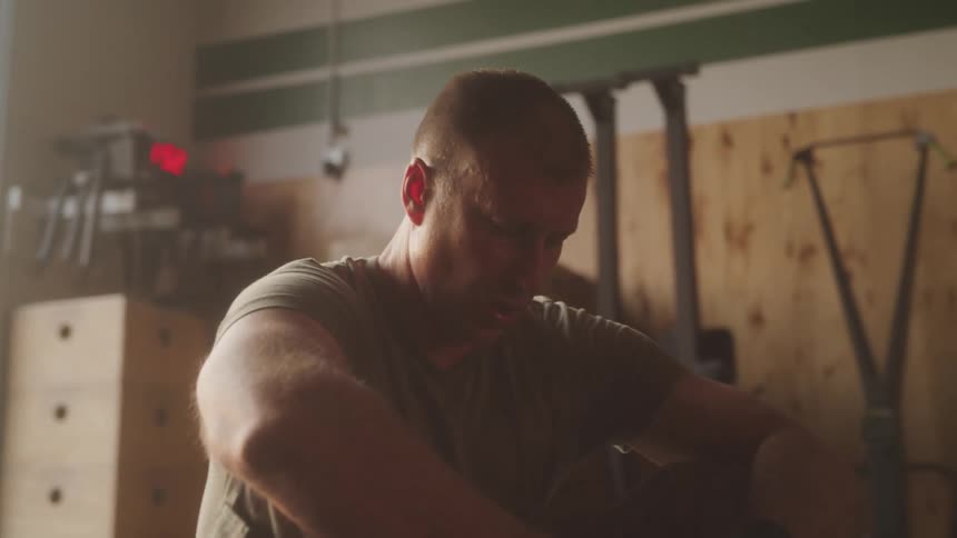 Man sitting taking a deep breath