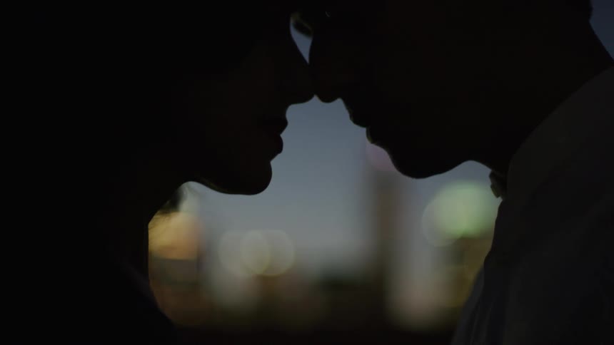 A man and woman are touching noses