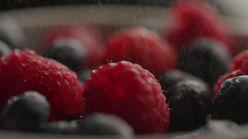 Sugar is sprinkled over the bowl of fruit
