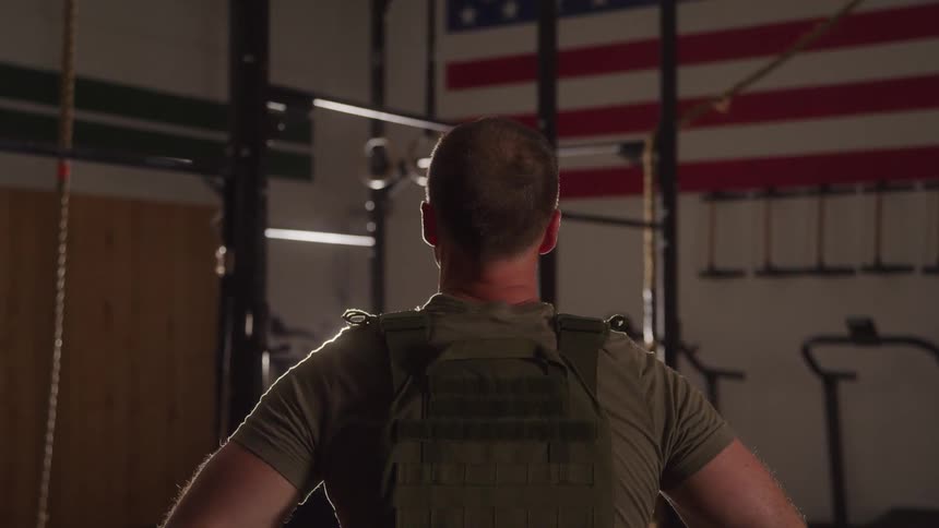 Man in military uniform inside a gym