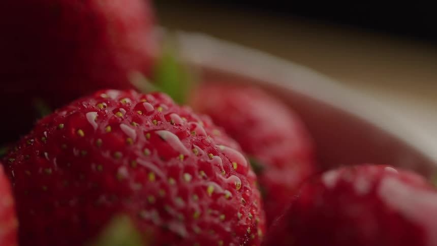 Close up of washed red ripe strawberries in a bowl