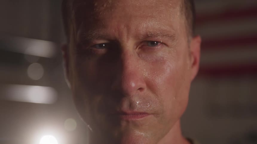 A mans face is covered in sweat