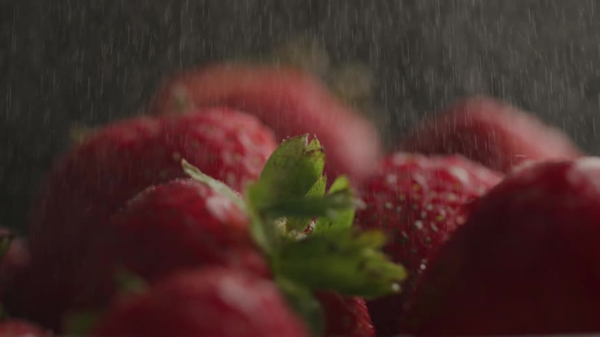 Liquid falling on strawberries