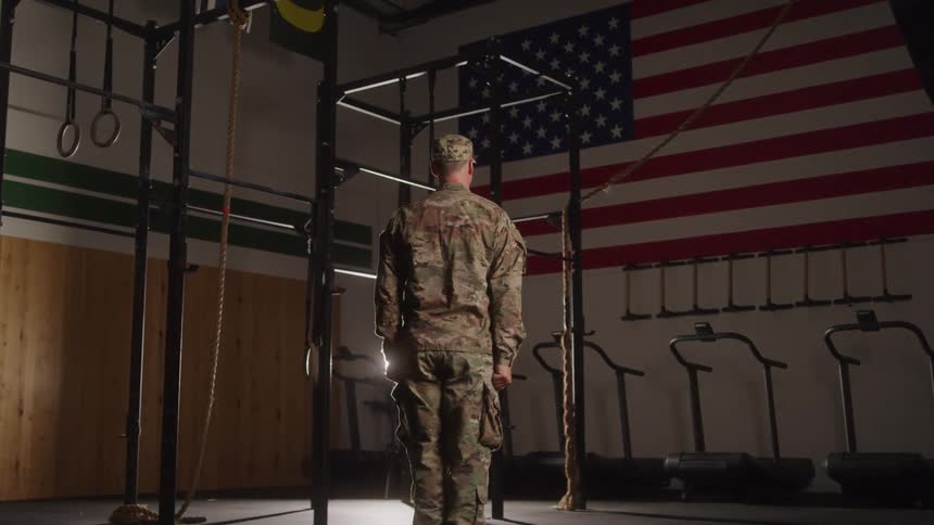 A military man saluting while facing a box
