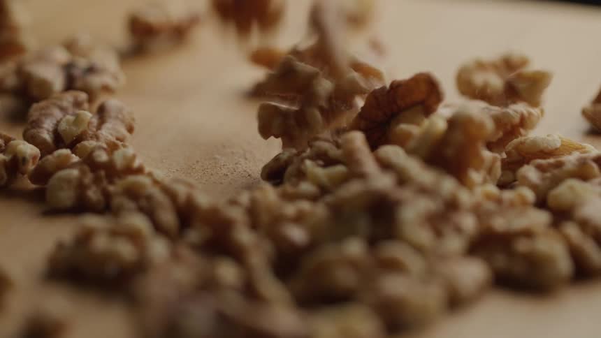 Walnuts falling on a wooden surface