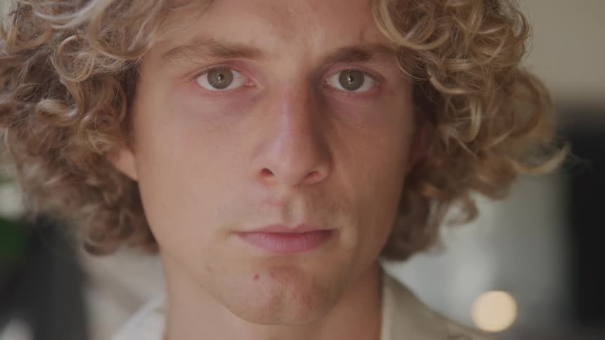 Curlyhaired man in an indoor space