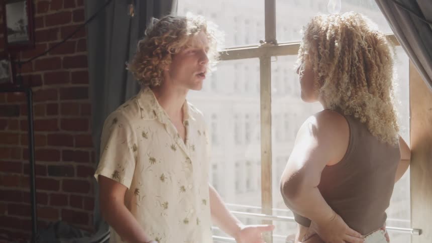 Two people are arguing by the window