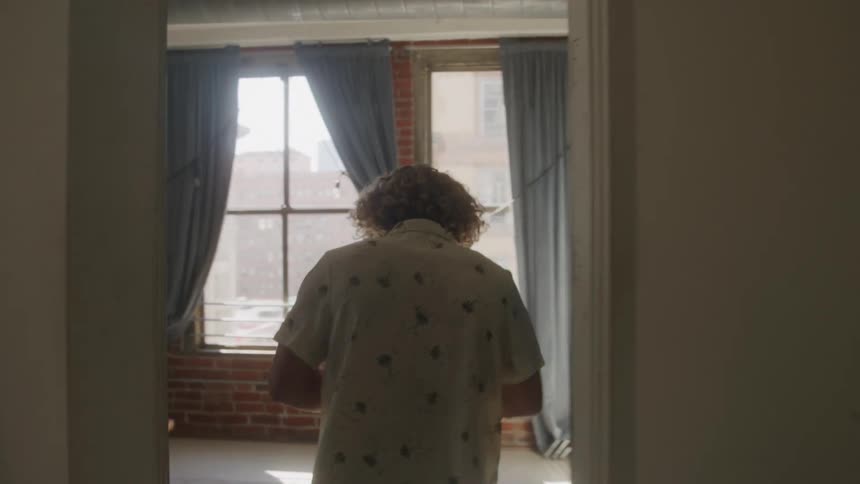 A man is angry as he throws papers while walking