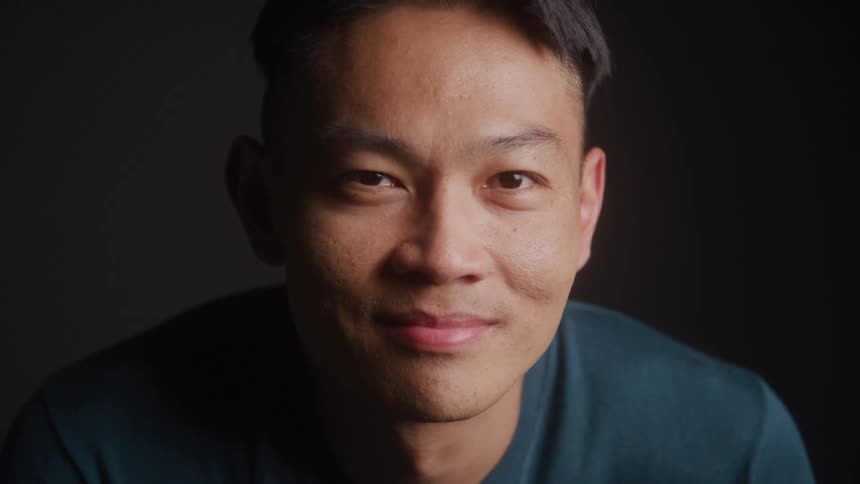 Man looks into camera with neutral expression
