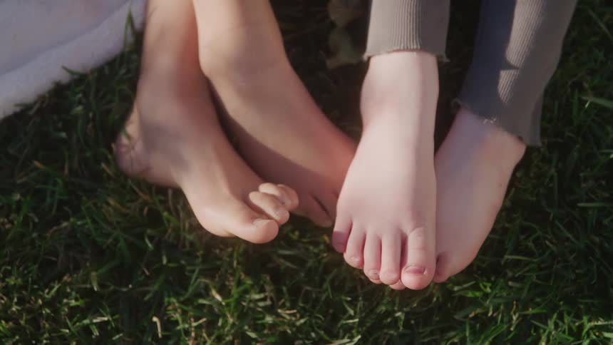 Two childrens feet in the grass